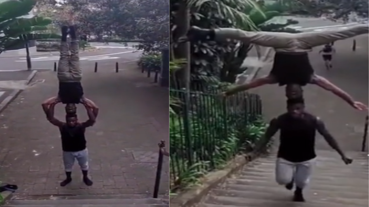 viral-video-man-climbs-stairs-while-balancing-another-upside-down-on