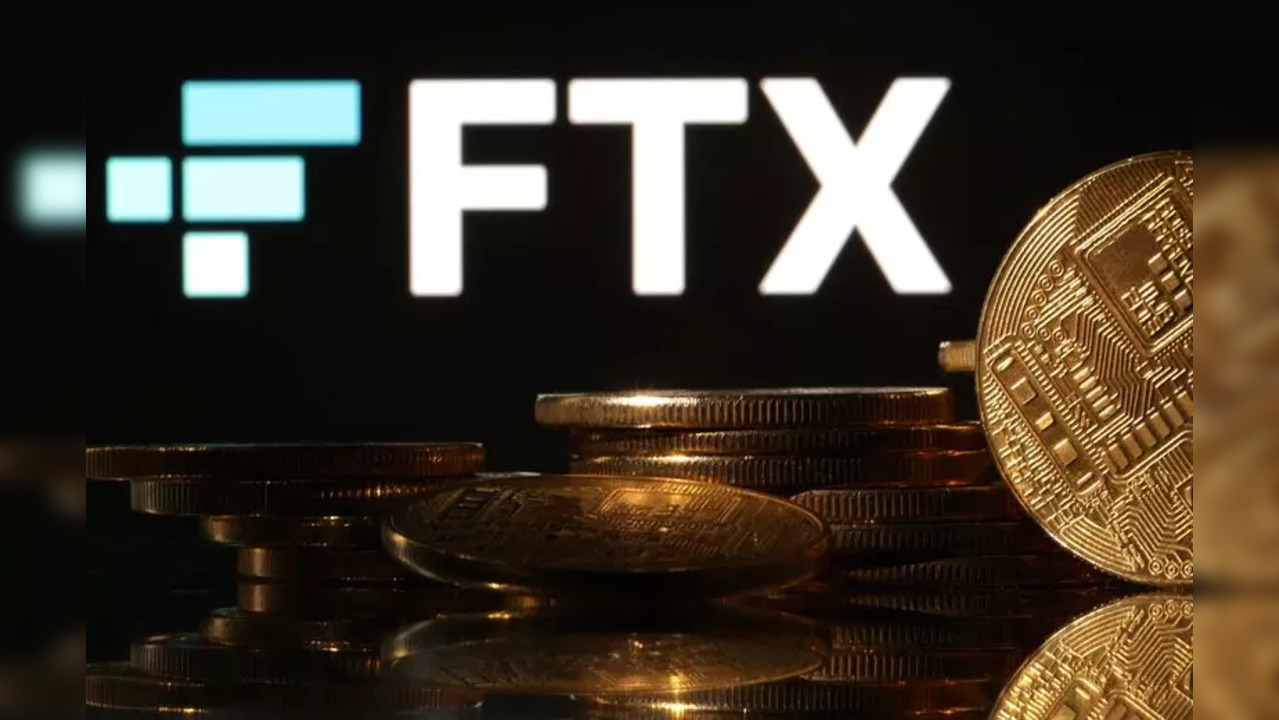 Representations of cryptocurrencies are seen in front of displayed FTX logo in this illustration.