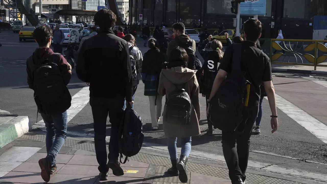 A group of young Iranian women cross a street without wearing their mandatory Islamic headscarves in Tehran