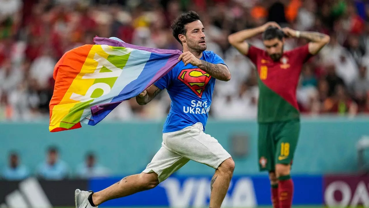 Man carrying a rainbow flag invaded the pitch during a match at the FIFA World Cup (1)