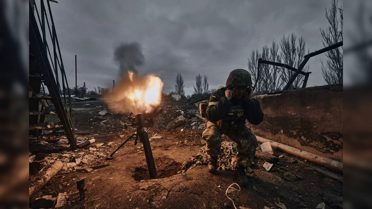 A Ukrainian soldier fires a mortar at Russian positions in Bakhmut