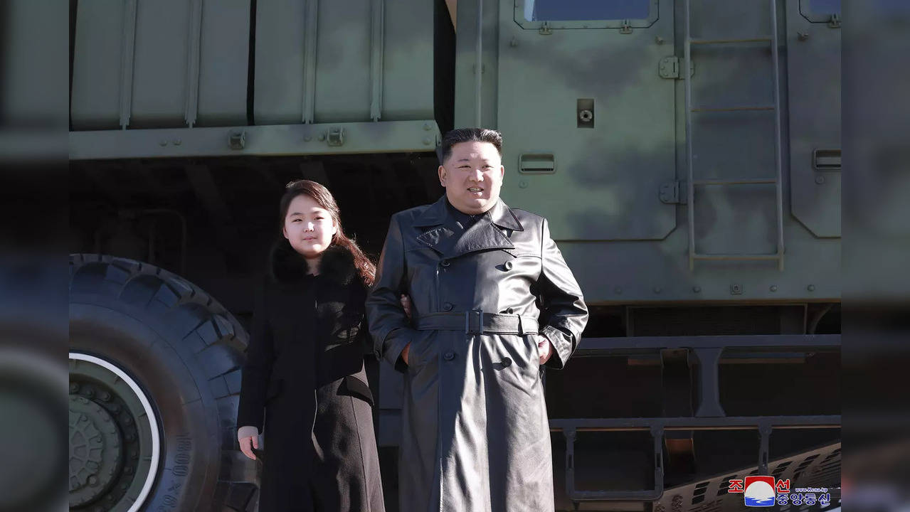 North Korean leader Kim Jong Un with his daughter in front of a military truck