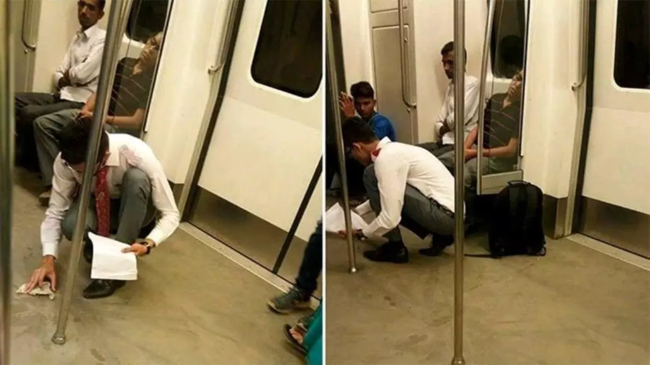 Young boy tears page from notebook to clean Delhi Metro