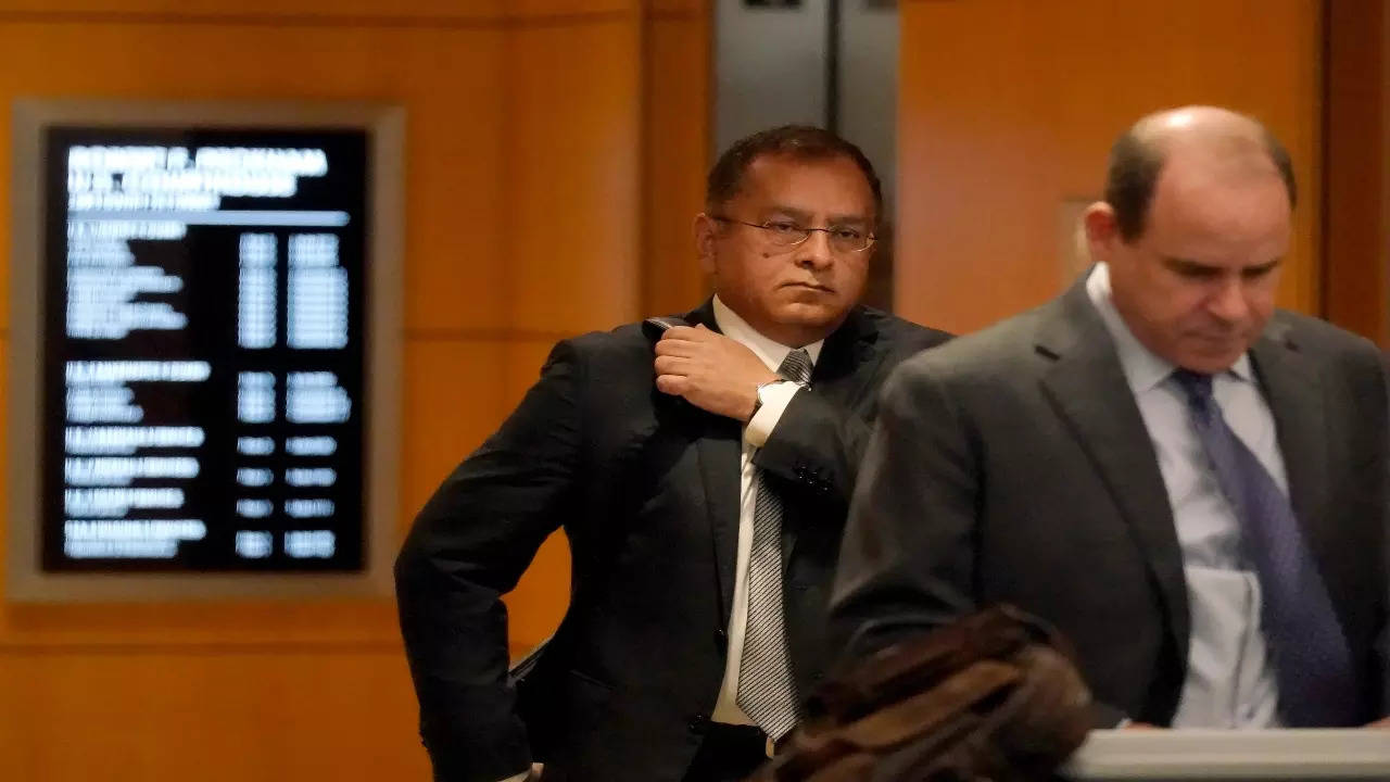 Ramesh 'Sunny' Balwani, the former lover and business partner of Theranos CEO Elizabeth Holmes, center, arrives at federal court in San Jose, Calif