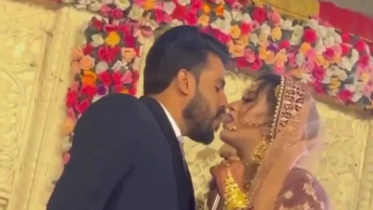 Viral video Bride and groom’s shotgun kiss sets wedding stage on fire