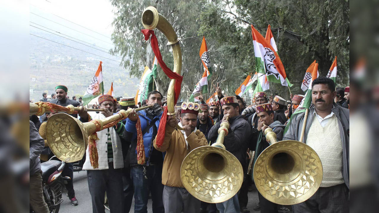 Congress workers celebrate the party's lead in Himachal Pradesh state elections