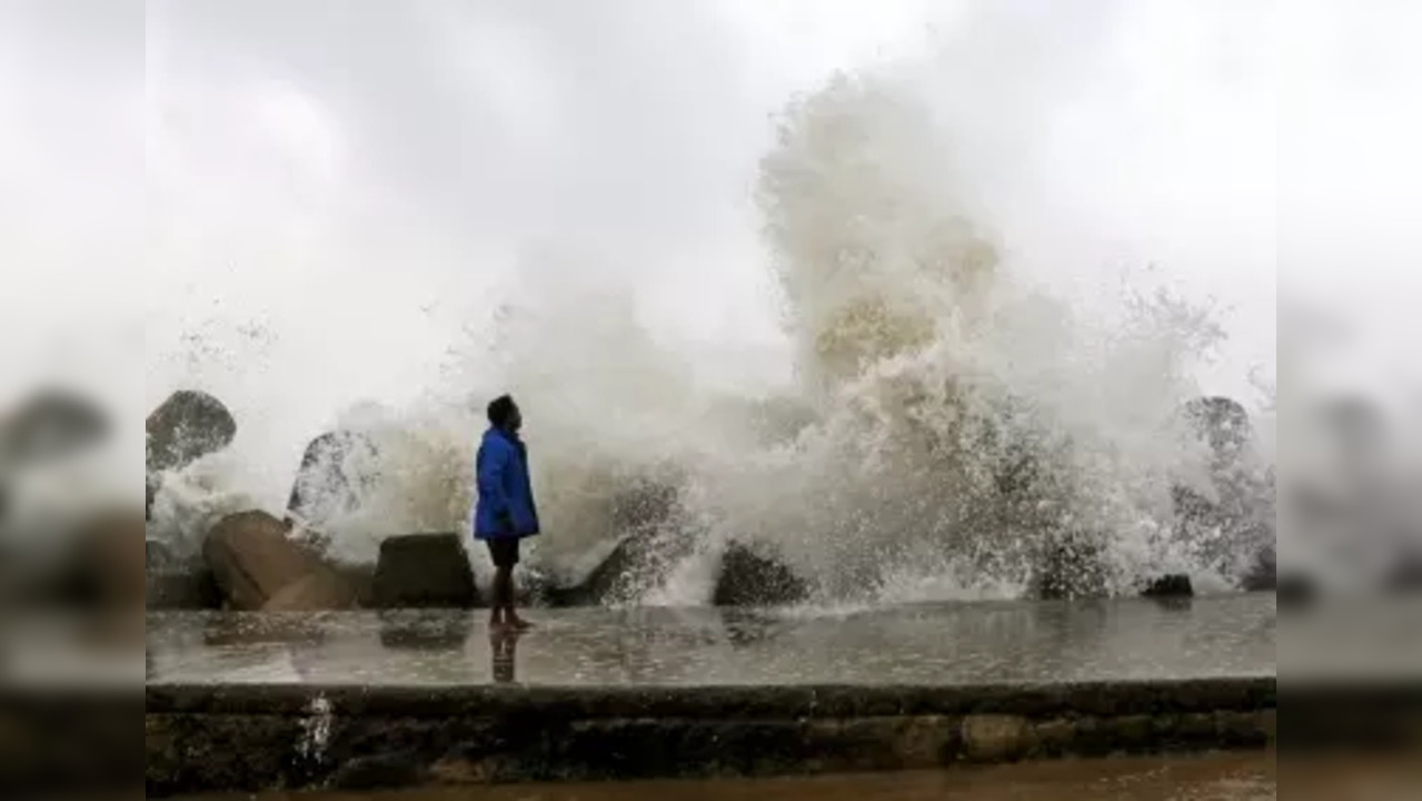 Chennai: A man seen standing as sea waves hits the shore due to the landfall of cyclone storm Mandous, in Chennai on Friday, Dec. 09, 2022. (Photo: Parthi Bhan/IANS)