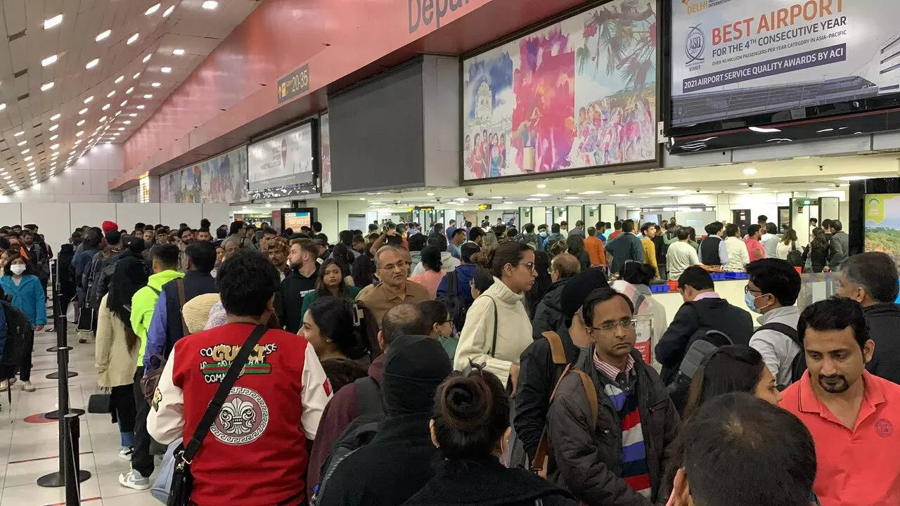 Passengers face long queues at Delhi Airport.