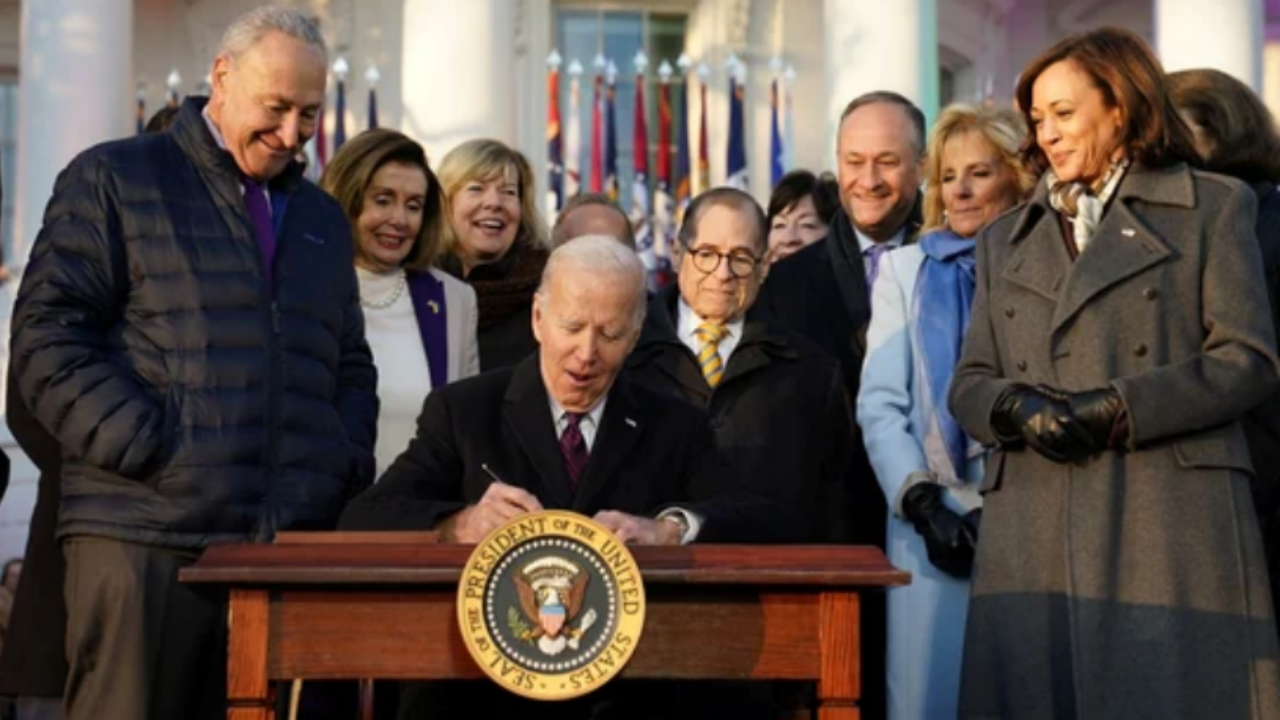 US President Joe Biden signs the 'Respect for Marriage Act,' a landmark bill protecting same-sex marriage, at the White House.