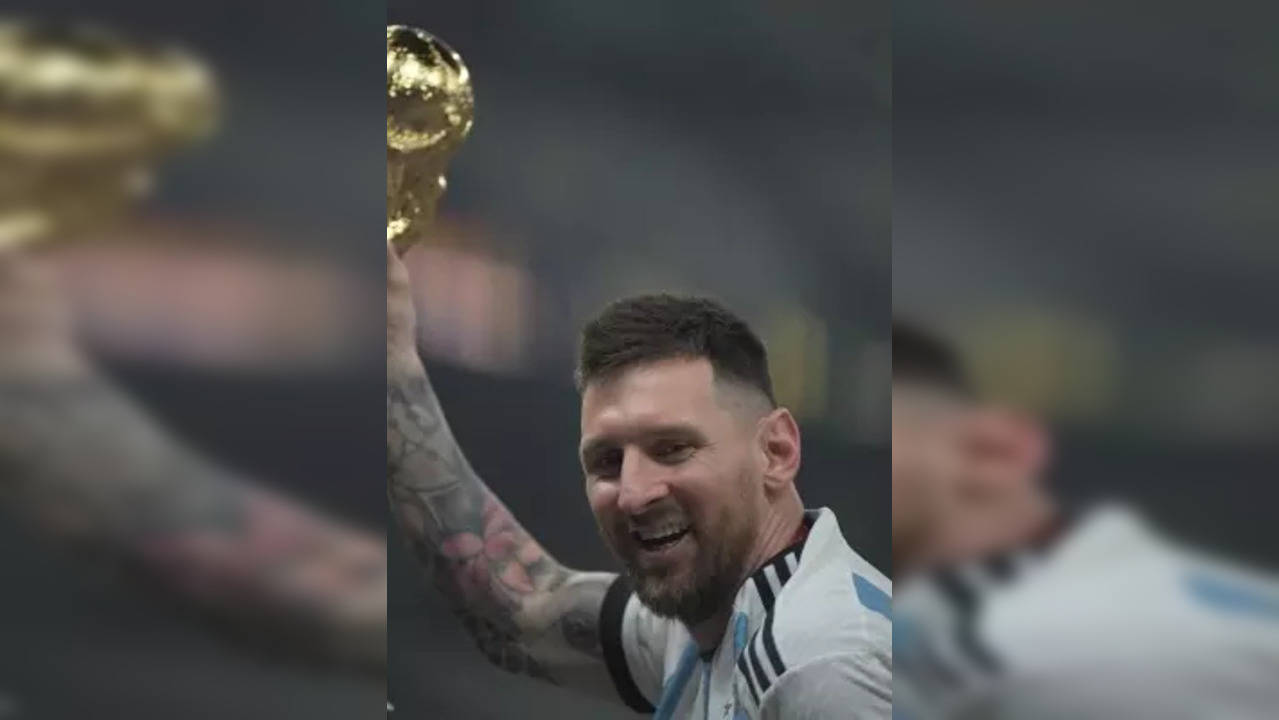 Lusail:Argentina's Lionel Messi celebrates with the trophy after winning the World Cup final soccer match between Argentina and France at the Lusail Stadium in Lusail, Qatar, Sunday, Dec.18, 2022 .(Photo:Suman Chattopadhyay/IANS)