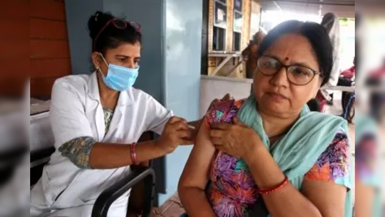 Bhopal: A health worker administers a precaution dose of Covid-19 vaccine to a woman under 'COVID Vaccination Amrit Mahotsava', in Bhopal on Friday, July 15, 2022. The programme was launched by Union Minister Mansukh Mandaviya, in which adults can get a free dose for the next 75 days. (PHOTO: IANS/Hukum Verma)