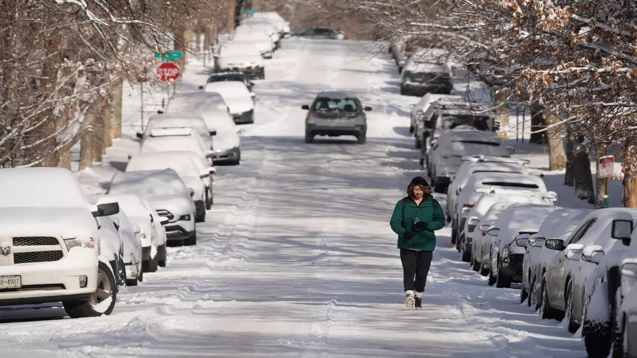 A lone pedestrian walks along Pearl Street while dealing with subzero temperatures after a winter storm swept over the intermountain West packing snow combined with Arctic cold Thursday, Dec. 22, 2022, in Denver