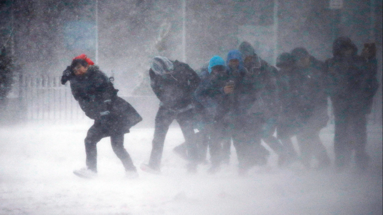 People struggle to walk amid winter storm