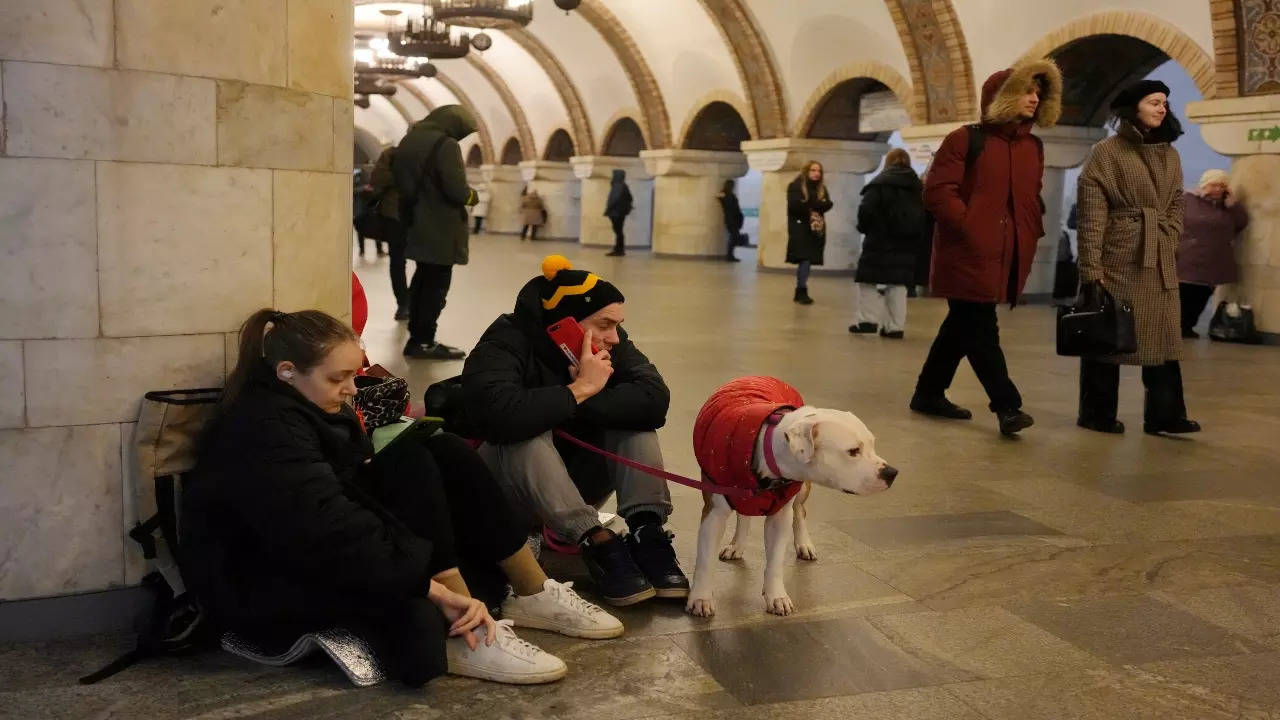 People rest in the subway station being used as a bomb shelter during a rocket attack in Kyiv