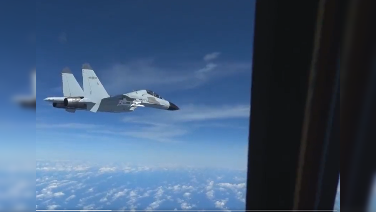 A Chinese J-11 fighter jet flies within 20 feet from US Air Force aircraft