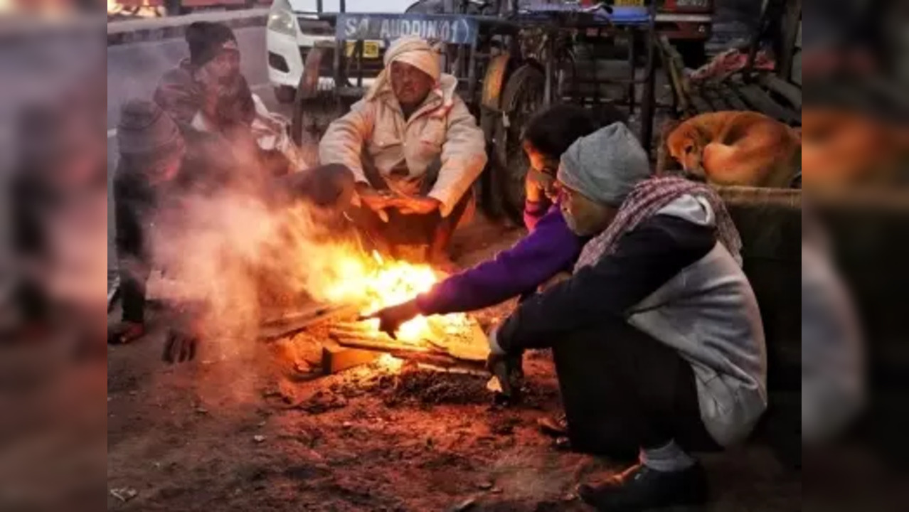 New Delhi: People keep themself warm by sitting around a bonfire on a cold day in the early morning in New Delhi on Friday, December 23, 2022. (Photo: Wasim Sarvar/IANS)