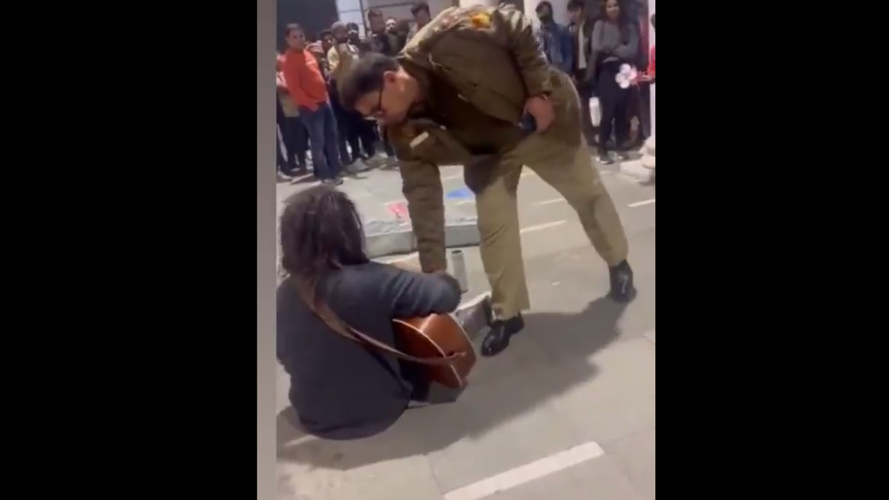 Delhi cop stops busker from playing music