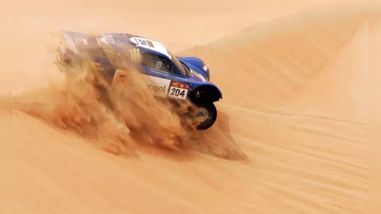 Veteran-rally-driver-Jean-Louis-Schlesser-on-his-way-to-a-stage-win-on-day-two-of-the-Abu-Dhabi-Desert-Challenge