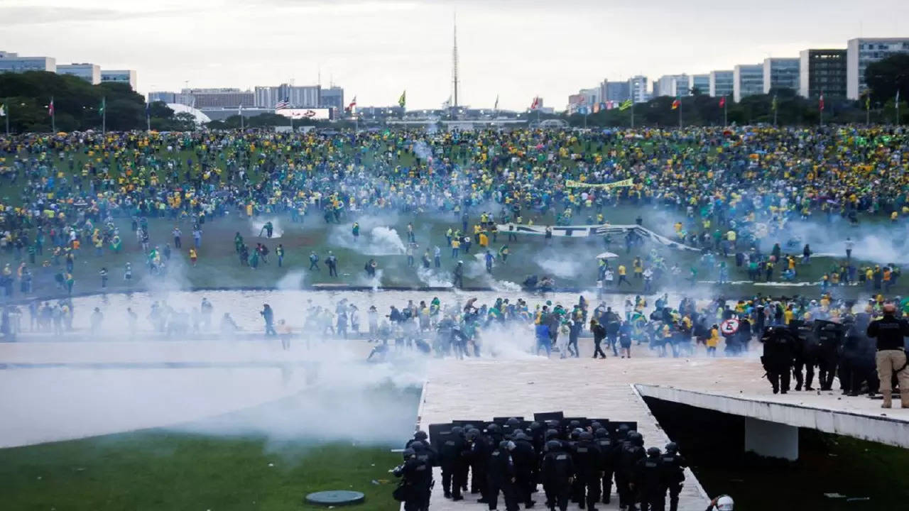 Supporters of Brazil's former President Jair Bolsonaro demonstrate against President Luiz Inacio Lula da Silva as security forces operate, outside Brazil’s National Congress in Brasilia.