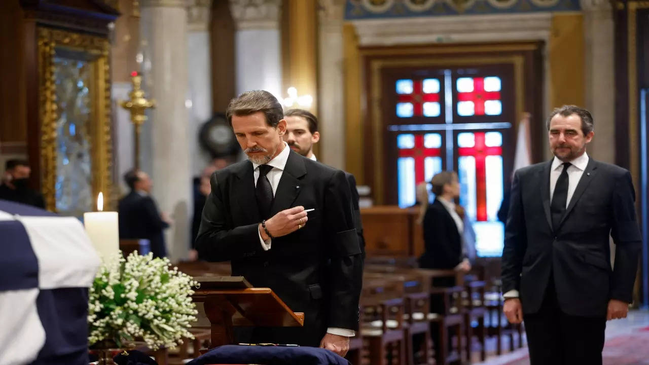 Prince Philippos, rear, Prince Pavlos, center, and Prince Nikolaos, right, sons of former king of Greece Constantine II stand in front of the coffin during funeral at Metropolitan Cathedral in Athens