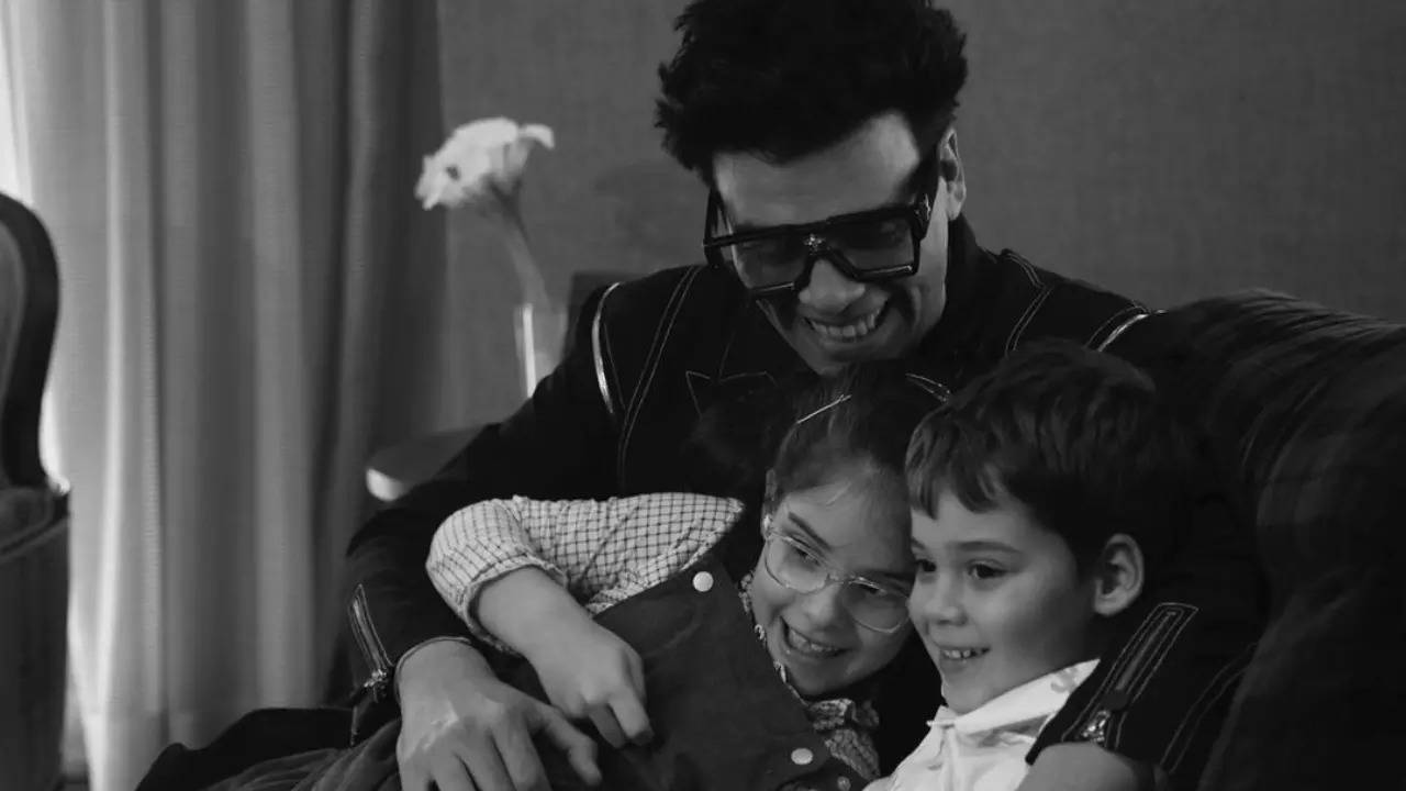 Karan Johar poses with his two munchkins