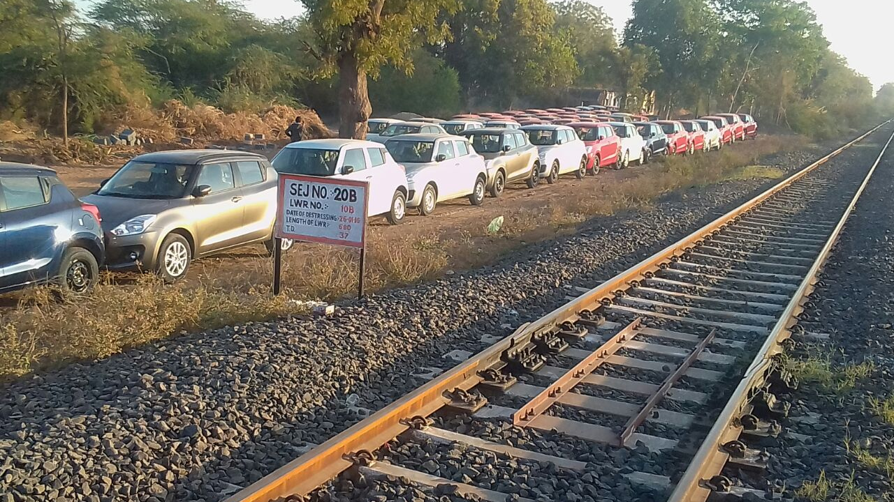 Maruti Suzuki cars next to a railways line