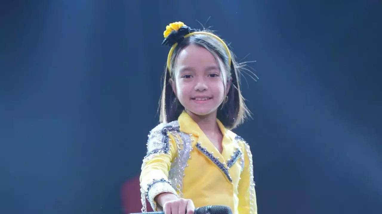 Jetshen Dohna Lama, 9, lifts up Sa Re Ga Ma Pa Li'l Champ's trophy