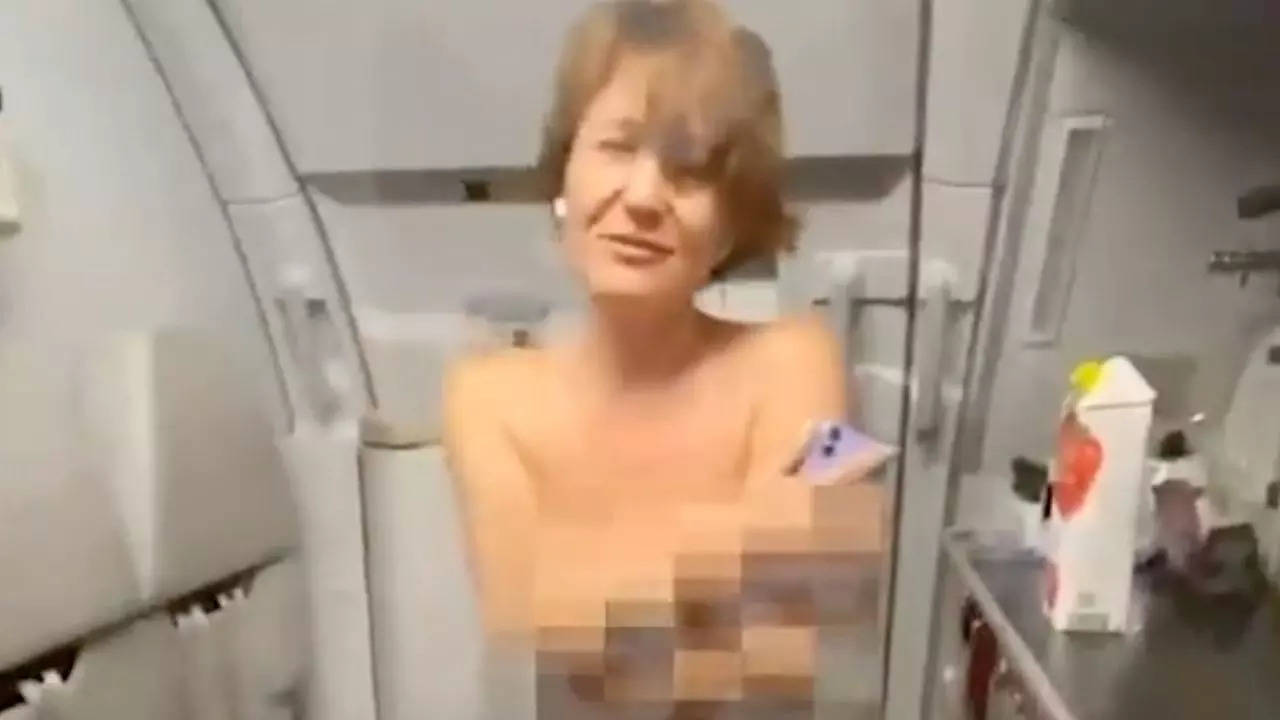 Russia topless air rage: 49-year-old Aeroflot passenger Anzhelika Moskvitina bared her chest in front of children, smoked in the toilet and then tried to break into the cockpit during a flight from Stavropol to Moscow | Screenshot: Mash