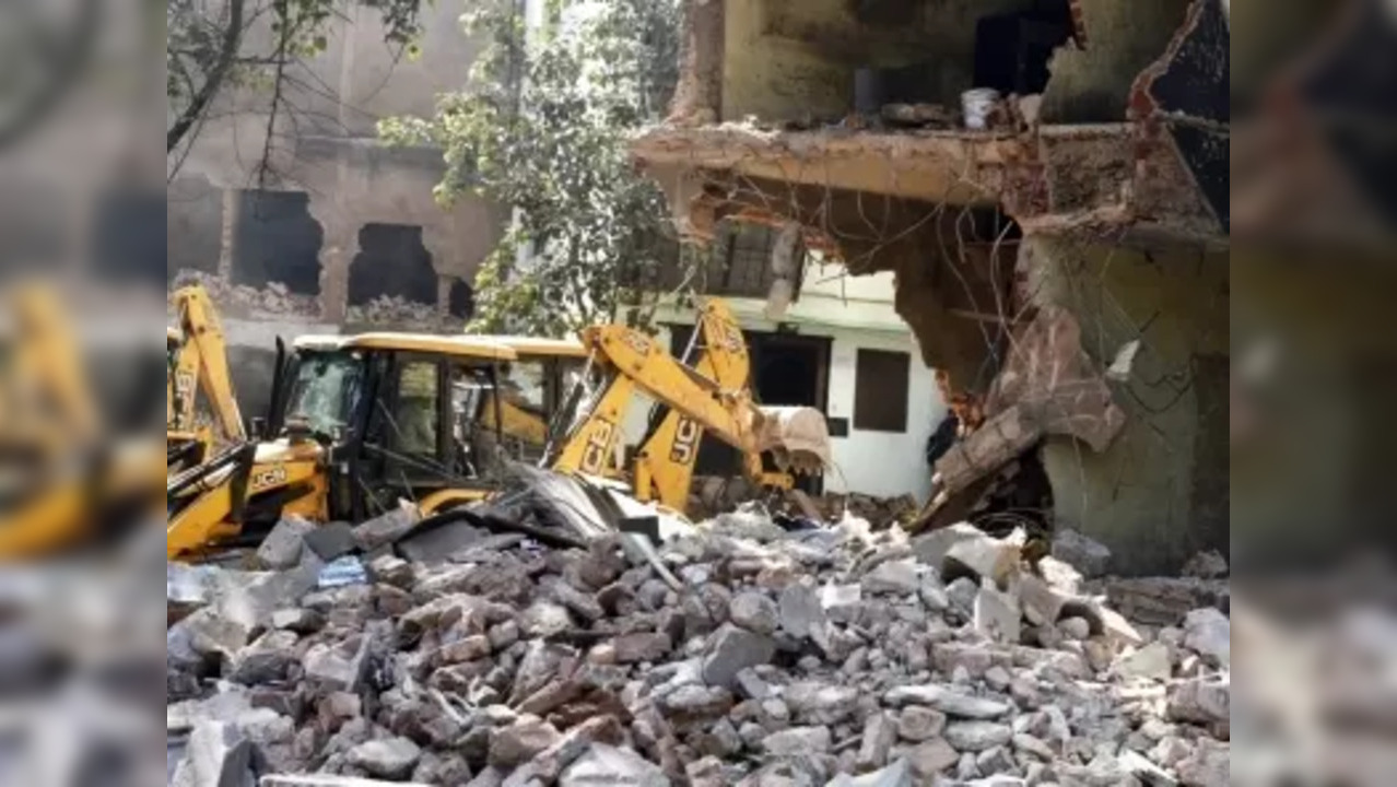 New Delhi: A JCB machine demolishes an illegal structure during an anti-encroachment drive by Delhi Development Authority (DDA) at Mehrauli in New Delhi, India on Tuesday, Feb. 14, 2023. (Photo: Wasim Sarvar/IANS)