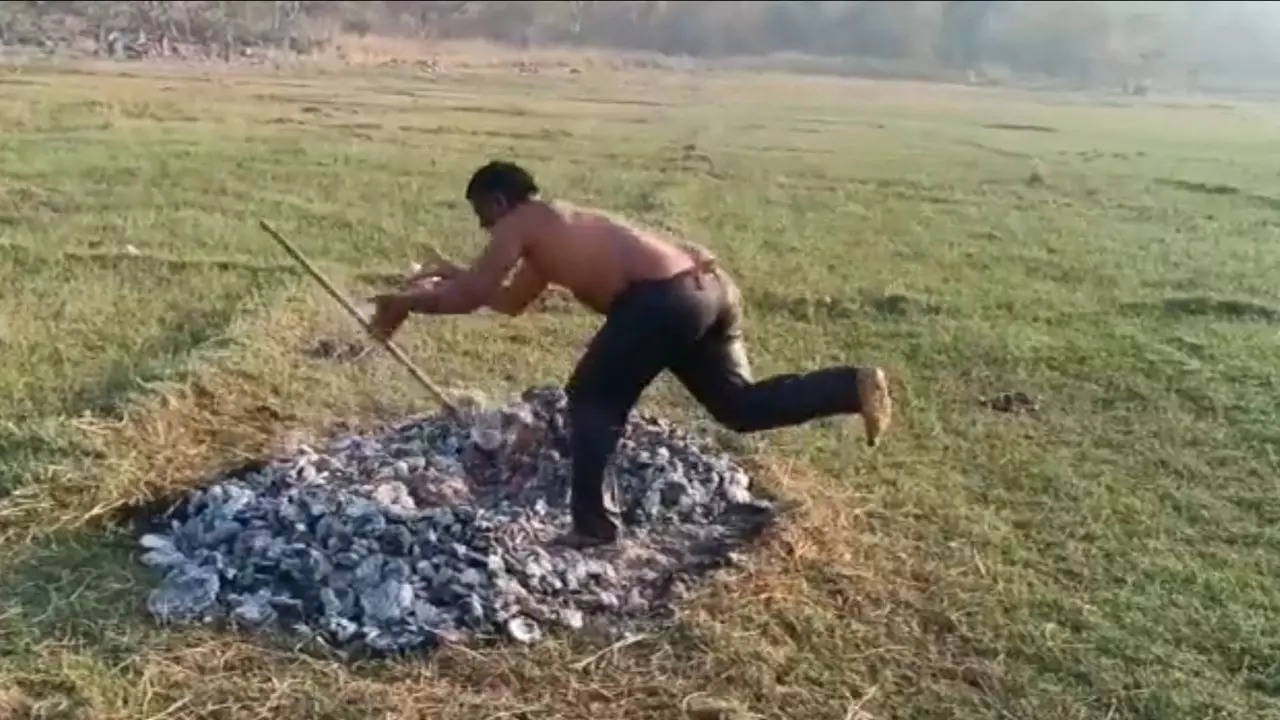 Telangana villager J Gangadhar moves an iron rod out of burning embers during a so-called 'Agnipareeksha' to prove he didn't have an affair with his older brother's wife | Screenshot