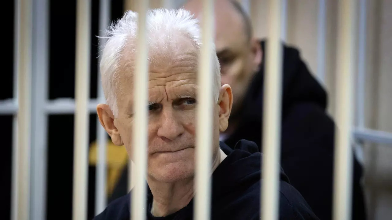 les Bialiatski, the head of Belarusian Vyasna rights group, sits in a defendants' cage during a cour