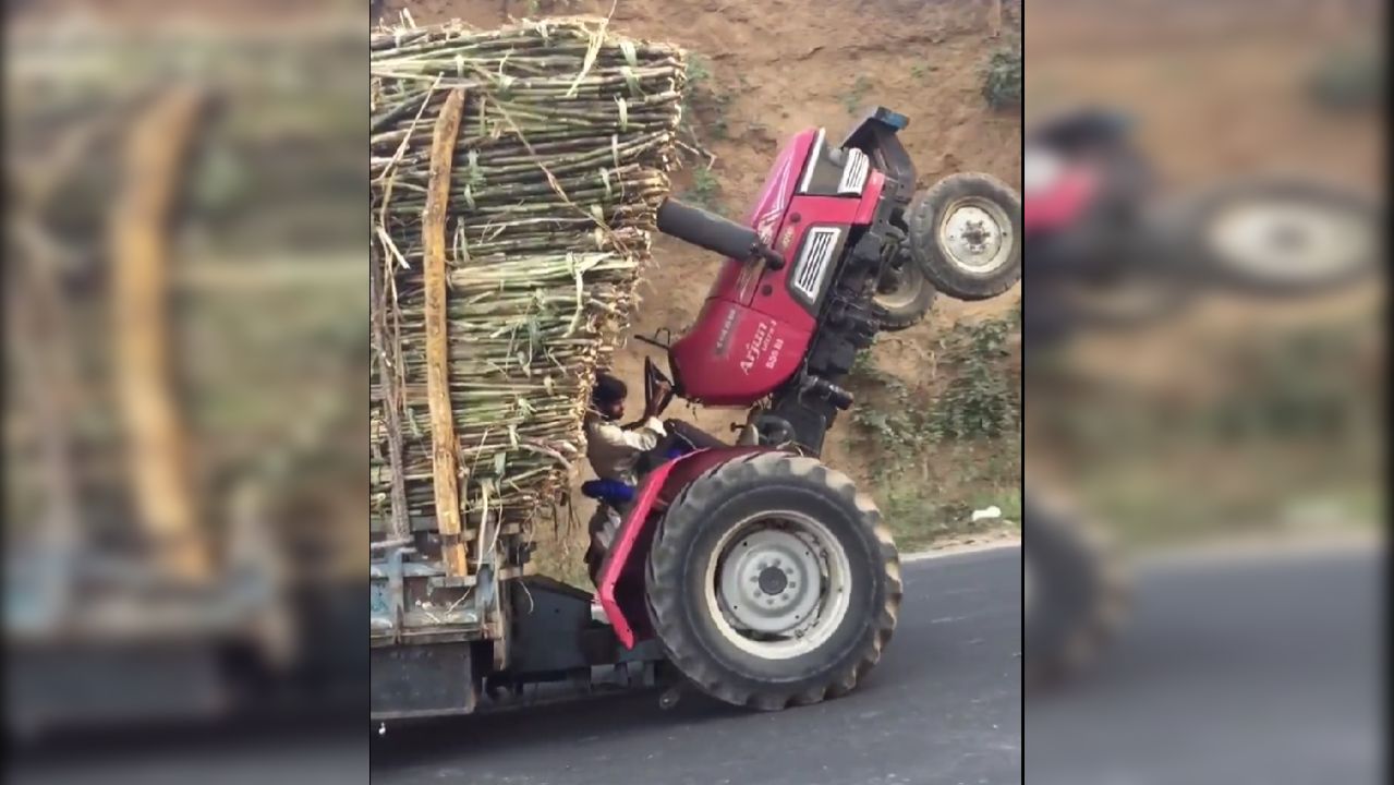 ​Man drives tractor on two wheels