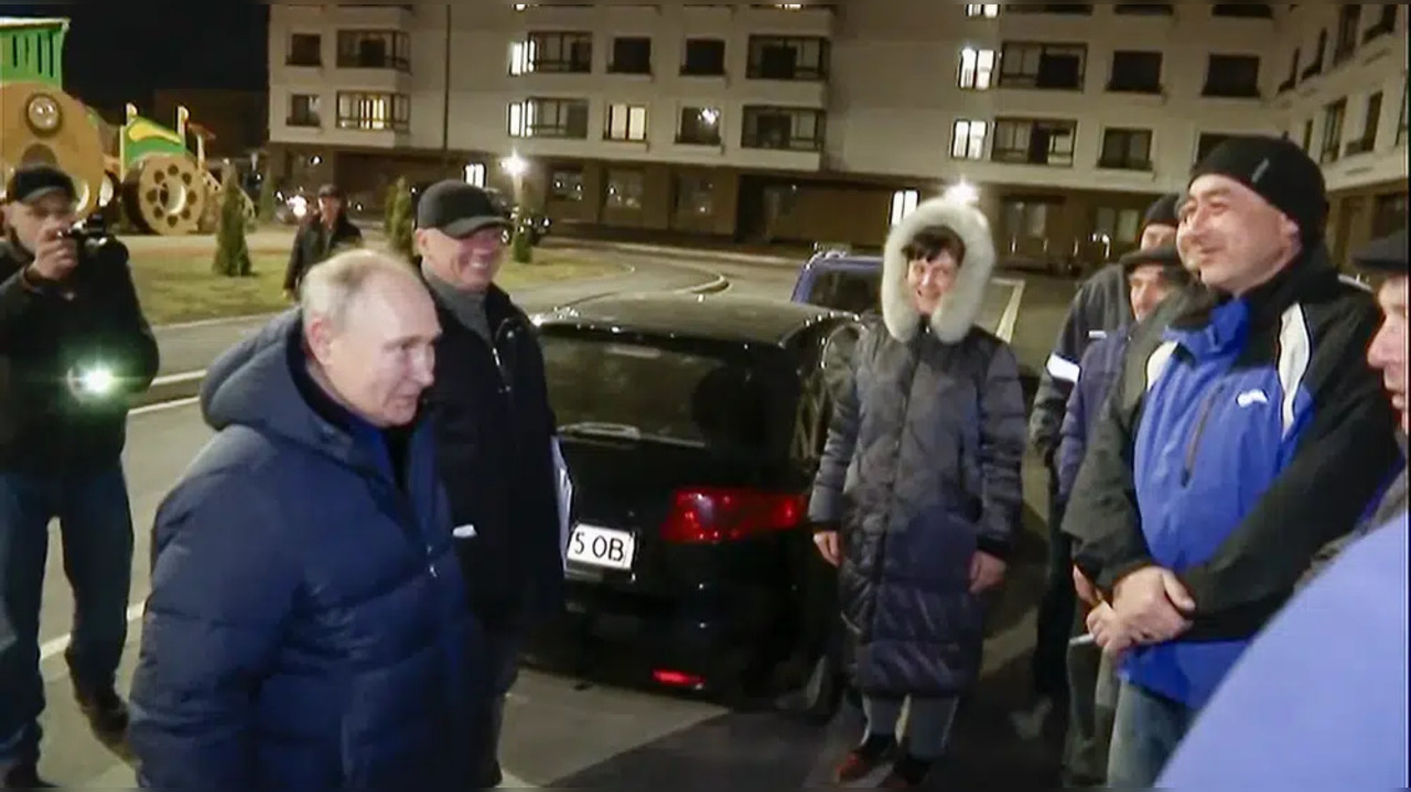 Russian President Vladimir Putin talks with local residents during his visit to Mariupol in Russian-controlled Donetsk region, Ukraine.