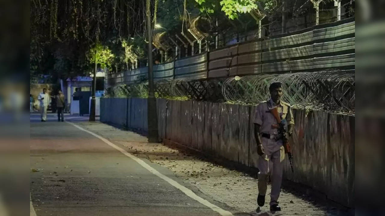 Security personnel outside 12, Tughlaq Lane