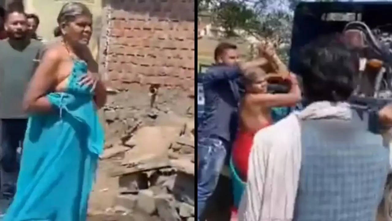 An elderly Dalit woman stands half-naked outside her home in Sagar, MP, after preventing employees of the MP Eastern Region Power Distribution Company from seizing her belongings for an unpaid electricity bill. | Screenshot