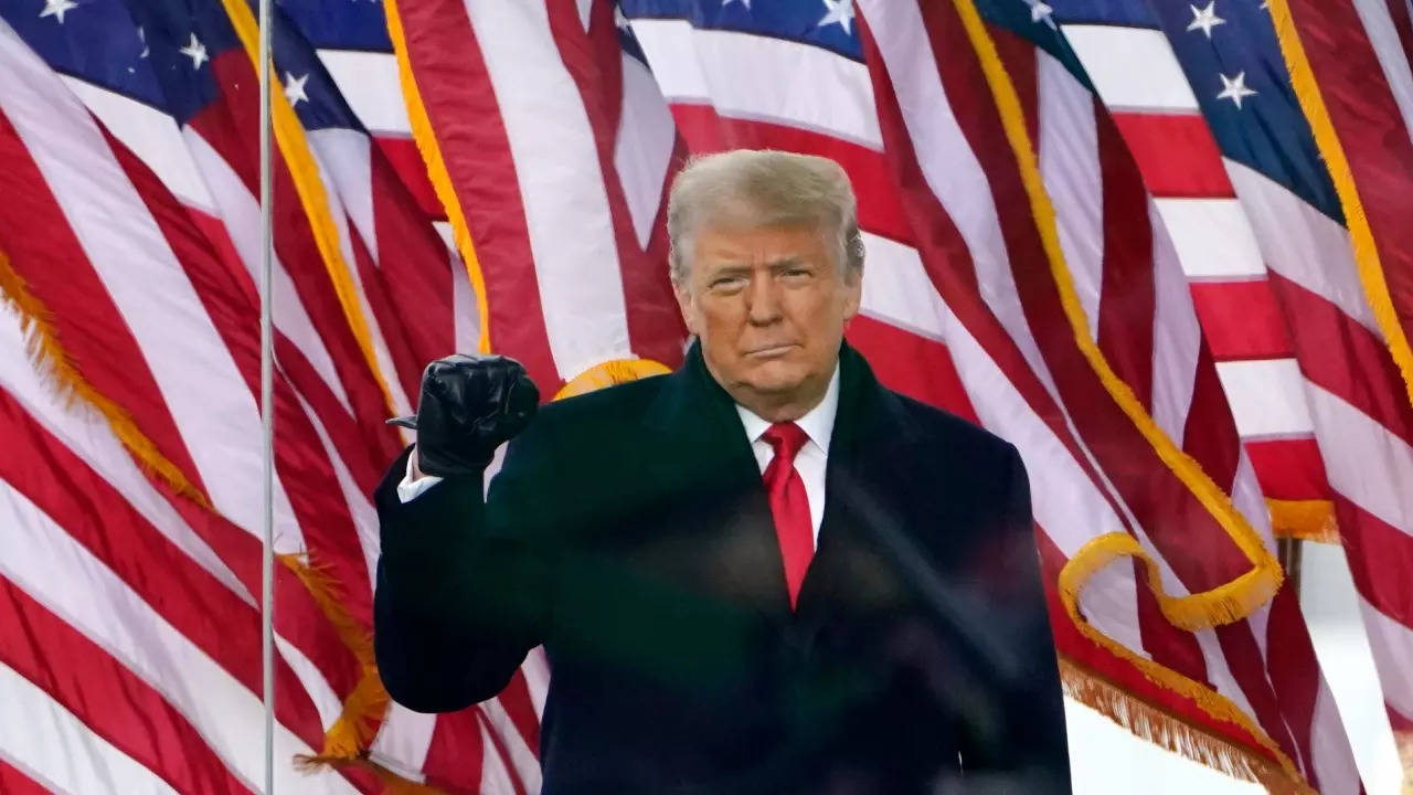 US President Donald Trump gestures as he arrives to speak at a rally in Washington - AP