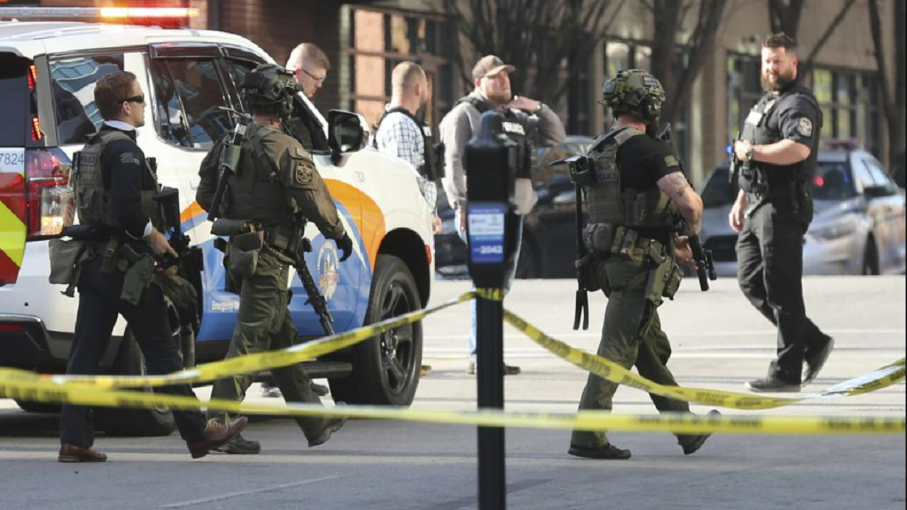 Multiple agencies arrive at a building after a shooting took place in Louisville