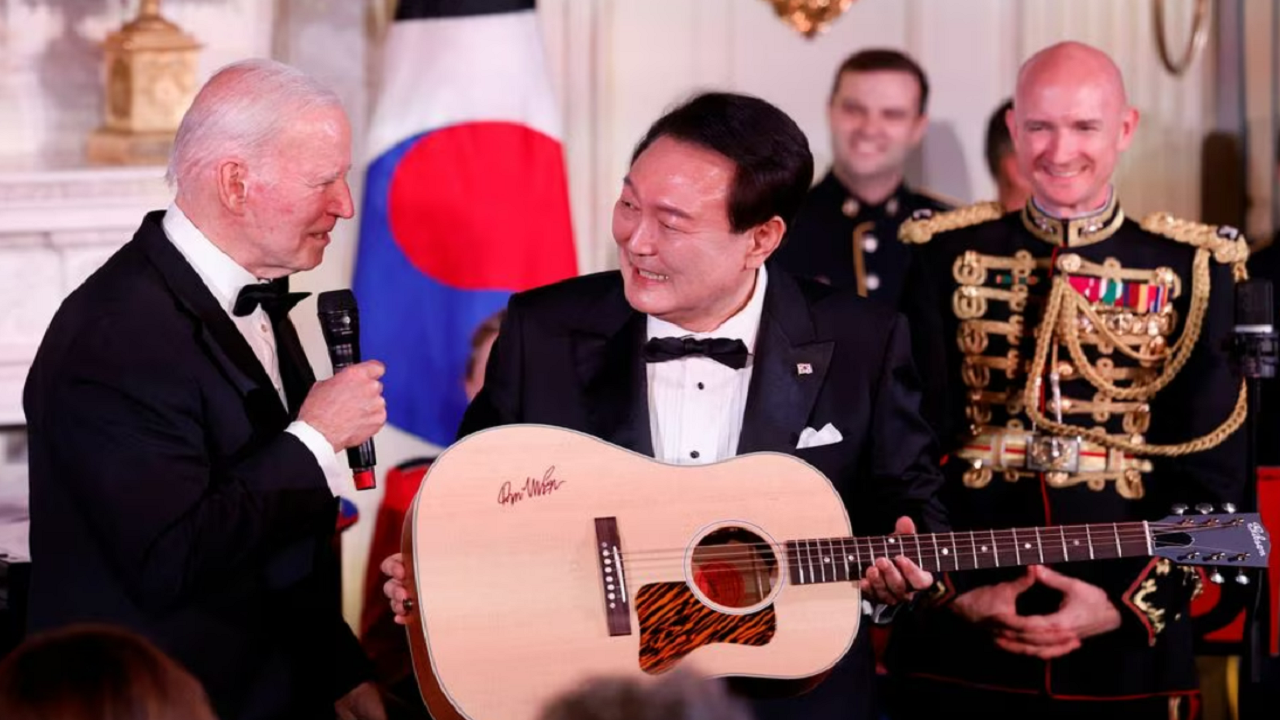 Joe Biden presents South Korean President with a guitar signed by the writer of the song Don McLean.